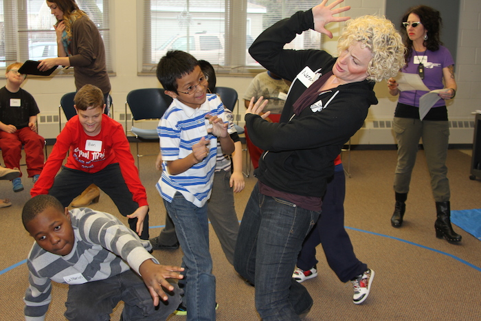 UA Teaching Artist Norah Long dancing with elementary school students in an Upstream Arts class