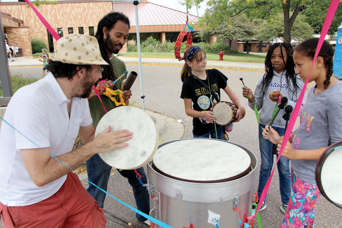 Teaching Artists Dylan Fresco and Anton Jones and kids playing the Wonder Drum